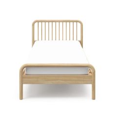 the bed frame is made from wood and has white sheets