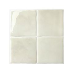 four square white tiles on a white background