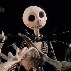 the jack skellingy skeleton is holding a branch