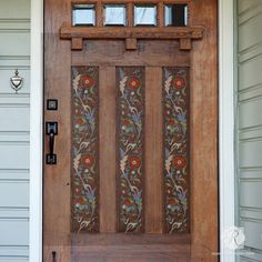 the front door is decorated with flowers and leaves