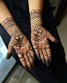 two hands with henna designs on them