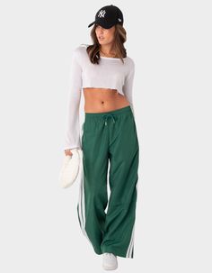 These Nylon Track Pants Offer Both Style And Comfort, Making Them Perfect For A Sporty Yet Fashionable Look. They're Ideal For Any Activity, Ensuring You Feel Comfortable And Confident Throughout Your Entire Day. Track Pants. Side Stripe Detail. Drawstring Waistband. 100% Polyester. Item Care: Wash With Similar Colors. Model Wears Size S. Model Height Is 5'8. | Edikted Fauna Nylon Track Pants Nylon Track Pants, Track Pants Outfit, Visionary Fashion, Track Pants Women, Side Stripe, Sport Pants, Pants Outfit, S Models, Pacsun