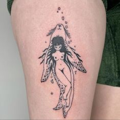 a woman's thigh with a mermaid tattoo on her left leg and an angel above her head