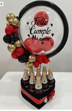 a bunch of balloons that are sitting on top of a stand with bottles in it