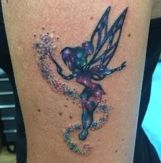 a woman's thigh with a tattoo on it that has an image of a tinkerbell