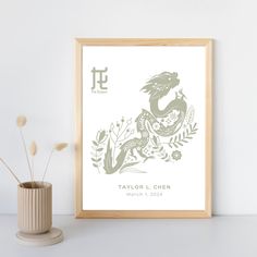 a framed print with the zodiac sign for tauo'l chen on it next to a potted plant