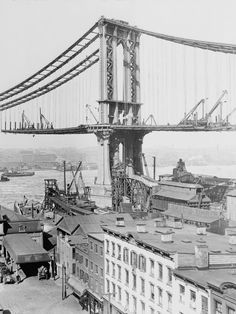 an old black and white photo of the brooklyn bridge