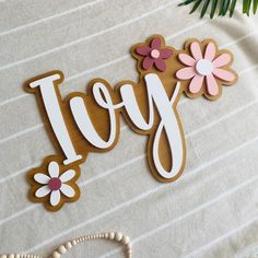 a wooden sign that says joy with flowers on it