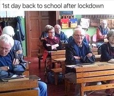 an old man sitting in front of a group of older people at desks with papers