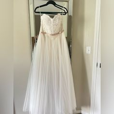 a dress hanging on a hanger in front of a mirror