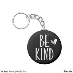 a black and white keychain with the words be kind written on it