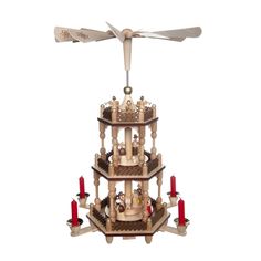 a wooden tower with candles and a ceiling fan on the top, in front of a white background