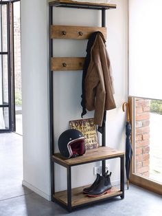 a coat rack with shoes and jackets on it