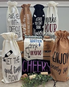 six wine bags with different sayings are sitting on the floor next to each other