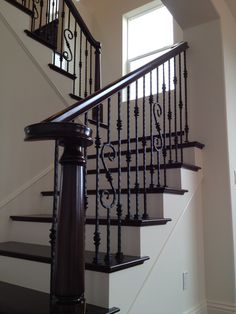 a staircase with railings and handrails in a home's entryway