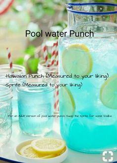 a pitcher filled with blue liquid sitting on top of a table next to glasses and lemon slices