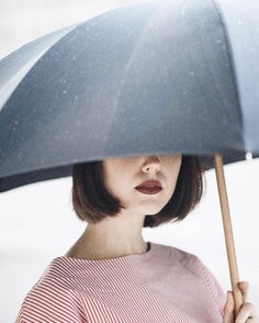 a woman holding an umbrella over her head