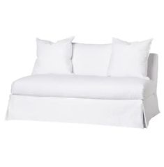 a white couch with four pillows on it