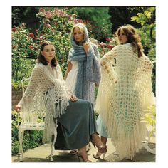 three women in crocheted shawls and dresses