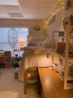 a bedroom with a bed, desk and shelves on the wall in front of it