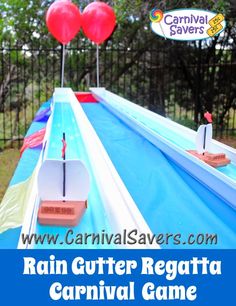 an inflatable water slide with red heart balloons on top and the words rain gutter regatta carnival game above it