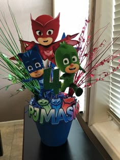 a vase filled with toys and decorations on top of a table