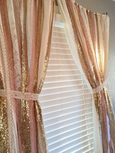 a window with gold sequins and pink curtains