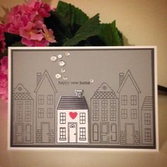 a handmade card with a house on it and flowers in the background that says happy home