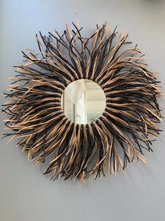 a circular mirror hanging on the wall