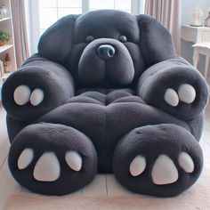 a large teddy bear shaped chair in the middle of a room