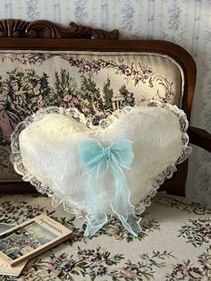 a heart shaped pillow sitting on top of a chair