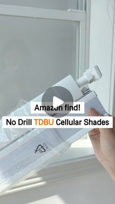 a person holding an object in their hand with the words amazon find no drill tbu cellular shades