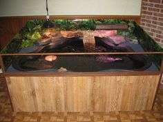 a fish tank filled with water next to a brick wall