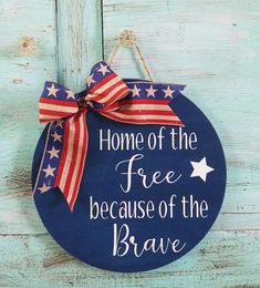 a sign that says, home of the free because of the brave with an american flag bow on it