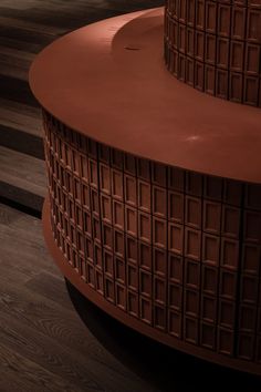 two large brown vases sitting on top of wooden flooring next to each other