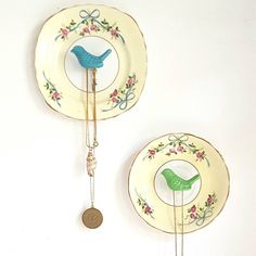 two plates with birds on them hanging from the wall