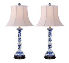 pair of blue and white porcelain lamps with shades on each lamp, one is turned off