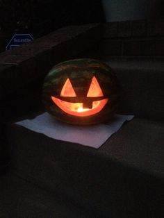 a carved pumpkin sitting on top of some steps