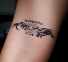 a tattoo with two hands holding each other and the words mementoo mori on it