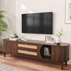 a flat screen tv mounted to the side of a wooden entertainment center