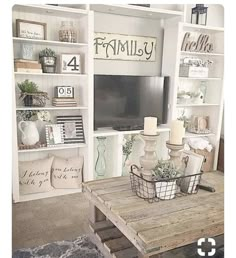 a living room filled with furniture and a flat screen tv sitting on top of a wooden table