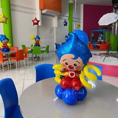 there is a balloon decoration on the table in the children's playroom with other toys