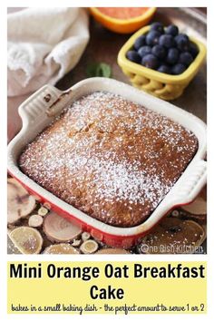 an orange oat breakfast cake in a baking dish with fresh blueberries on top