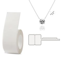 a white roll of tape next to a necklace with a diamond pendant on the end