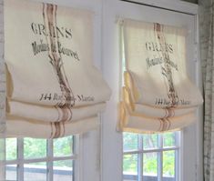 two windows with roman blinds in front of them and the words grisss on them