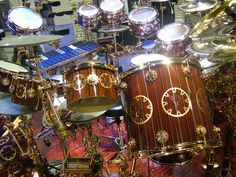 a set of drums sits on display in a room with other musical instruments and accessories