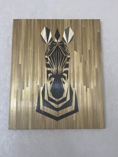 a zebra's head is painted on a wood panel