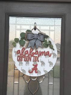 the front door is decorated with an elephant wreath and welcome sign for alabama crimson tide