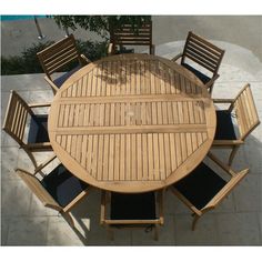 an overhead view of a wooden table and chairs on a patio with tile flooring