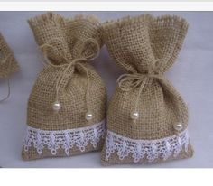 three burlap bags with white lace on them